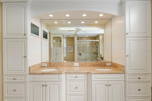 bathroom featuring a stall shower, recessed lighting, and a sink