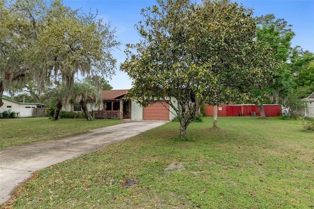 1366 N Merlin Ter, Crystal River, FL 34429 - obstructed view of property with concrete driveway, stucco siding, a front yard, fence, and a garage
