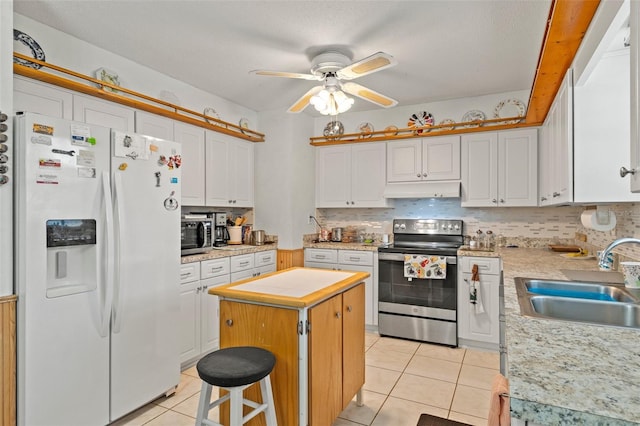 1366 N Merlin Ter, Crystal River, FL 34429 - kitchen featuring a sink, a ceiling fan, a kitchen island, light countertops, and appliances with stainless steel finishes