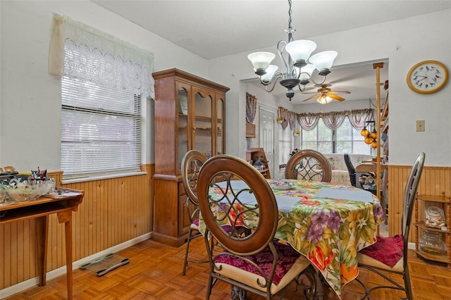 1366 N Merlin Ter, Crystal River, FL 34429 - dining area featuring wooden walls, a wainscoted wall, and ceiling fan with notable chandelier