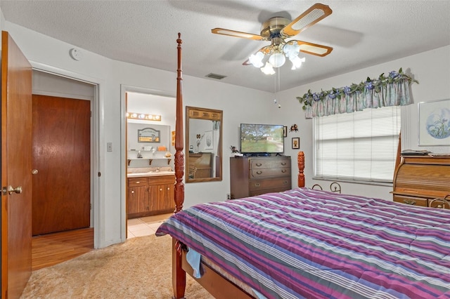 1366 N Merlin Ter, Crystal River, FL 34429 - bedroom featuring a textured ceiling, visible vents, ensuite bathroom, and a ceiling fan