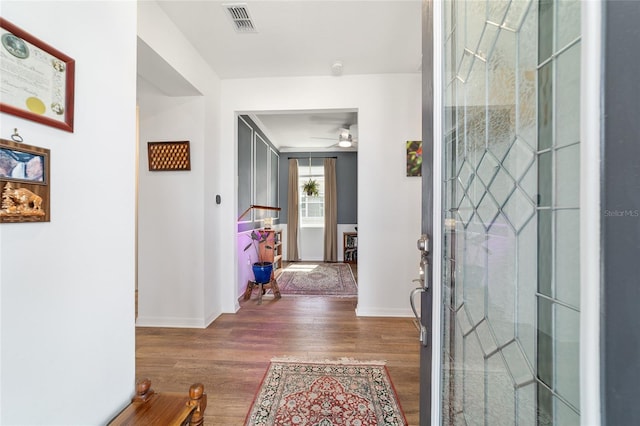 hallway with wood finished floors and baseboards