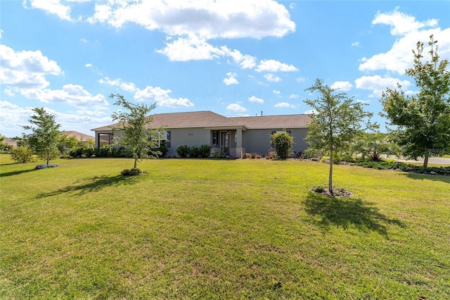 view of front of house with a front yard and stucco siding