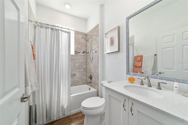 bathroom featuring shower / bath combo with shower curtain, vanity, wood finished floors, and toilet