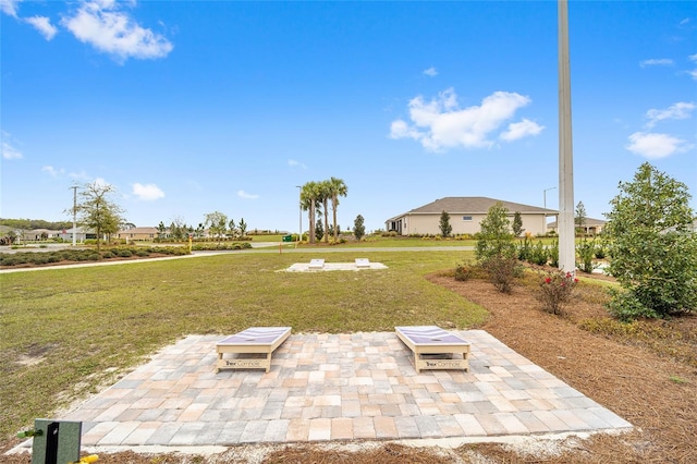 view of grassy yard with a patio