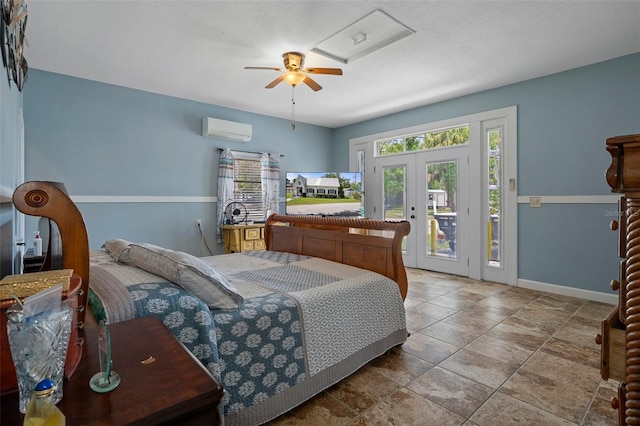 bedroom featuring ceiling fan, access to exterior, baseboards, attic access, and a wall mounted air conditioner