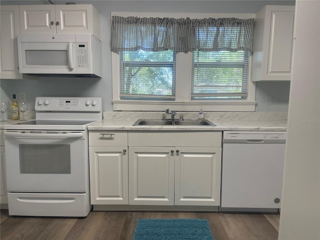 621 NE 20th St, Ocala, FL 34470 - kitchen with white appliances, a sink, white cabinetry, and plenty of natural light