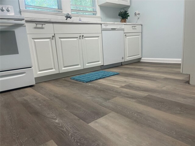621 NE 20th St, Ocala, FL 34470 - kitchen with white appliances, white cabinetry, and dark wood finished floors