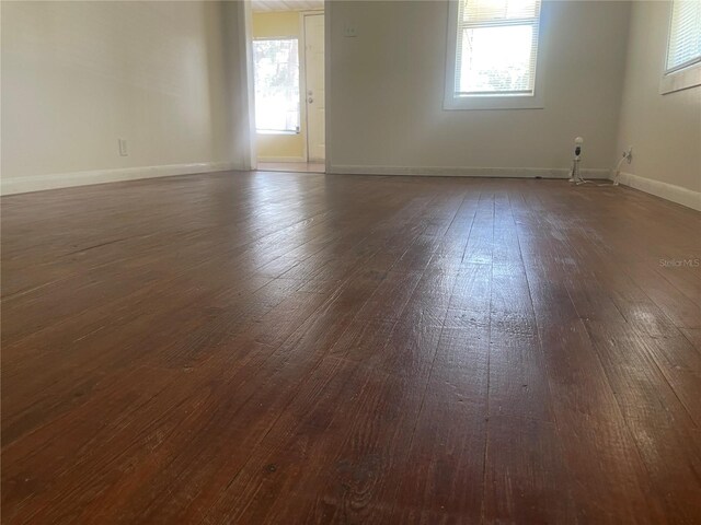 621 NE 20th St, Ocala, FL 34470 - unfurnished room featuring dark wood-style flooring and baseboards