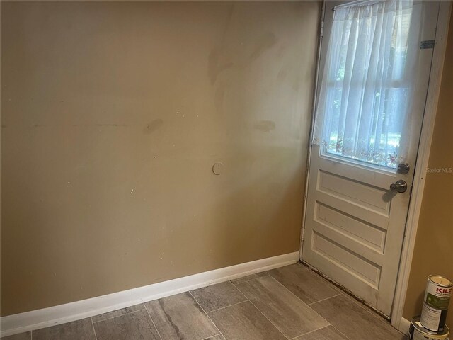 621 NE 20th St, Ocala, FL 34470 - doorway to outside featuring baseboards