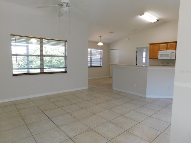 unfurnished room with light tile patterned floors, ceiling fan, lofted ceiling, and baseboards