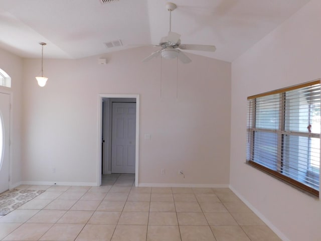 empty room featuring light tile patterned flooring, ceiling fan, visible vents, baseboards, and lofted ceiling