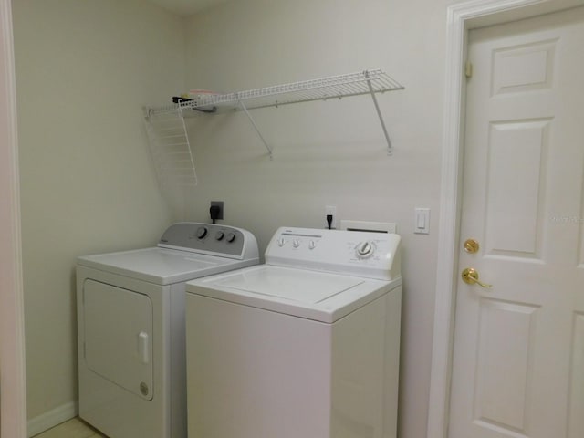 clothes washing area featuring independent washer and dryer and laundry area