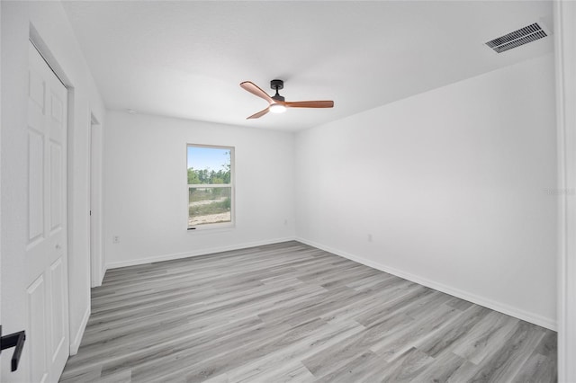 unfurnished bedroom featuring visible vents, a ceiling fan, light wood finished floors, and baseboards