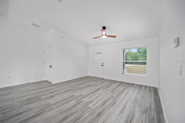 empty room with a ceiling fan, visible vents, baseboards, and light wood-type flooring