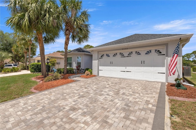 9452 SW 93rd Loop, Ocala, FL 34481 - ranch-style home with a garage, a front lawn, decorative driveway, stucco siding, and central AC unit