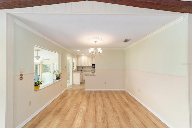 1179 SE 170th Ct, Silver Springs, FL 34488 - unfurnished living room with a chandelier, light wood-style flooring, and ornamental molding