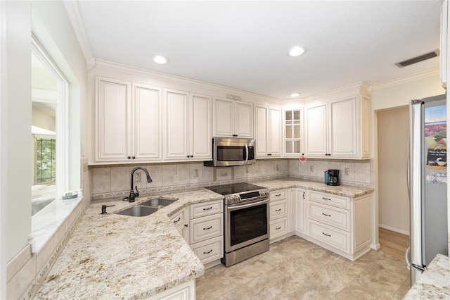 1179 SE 170th Ct, Silver Springs, FL 34488 - kitchen with stainless steel appliances, decorative backsplash, light stone countertops, plenty of natural light, and crown molding