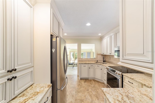 1179 SE 170th Ct, Silver Springs, FL 34488 - kitchen featuring stainless steel appliances, ornamental molding, light stone counters, recessed lighting, and a peninsula