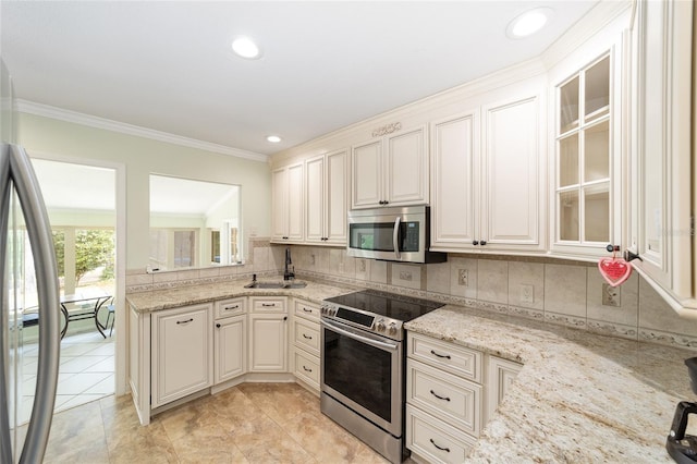 1179 SE 170th Ct, Silver Springs, FL 34488 - kitchen with stainless steel appliances, backsplash, crown molding, light stone countertops, and glass insert cabinets