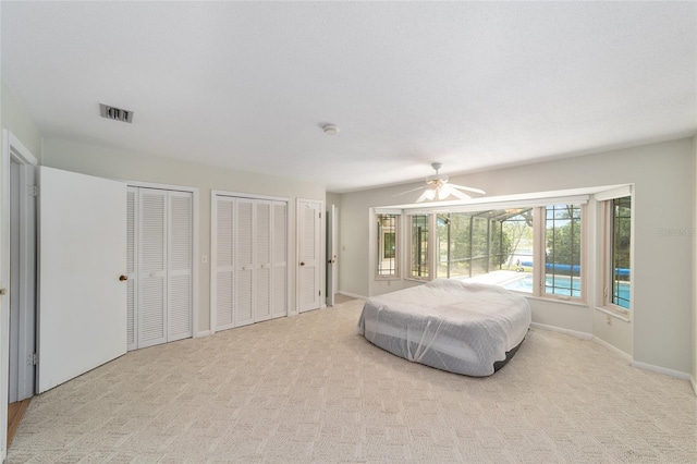 1179 SE 170th Ct, Silver Springs, FL 34488 - bedroom with two closets, carpet flooring, and a ceiling fan