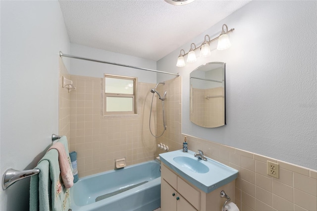 1179 SE 170th Ct, Silver Springs, FL 34488 - full bathroom featuring shower / tub combination, vanity, a textured ceiling, tile walls, and a wainscoted wall