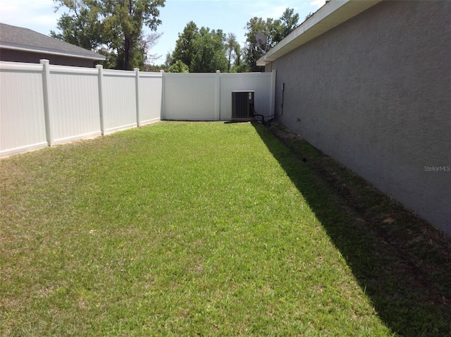 15266 SW 44th Ter, Ocala, FL 34473 - view of yard with a fenced backyard and central AC unit