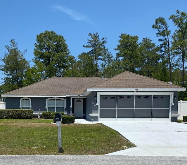 15266 SW 44th Ter, Ocala, FL 34473 - ranch-style home featuring a garage, a front yard, roof with shingles, stucco siding, and concrete driveway
