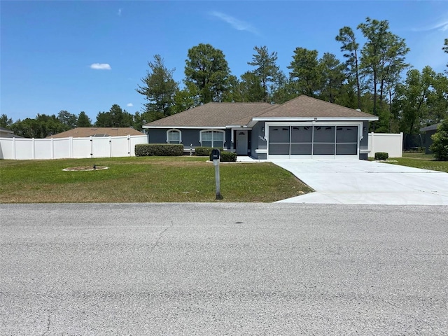 15266 SW 44th Ter, Ocala, FL 34473 - ranch-style home with fence, an attached garage, concrete driveway, and a front yard