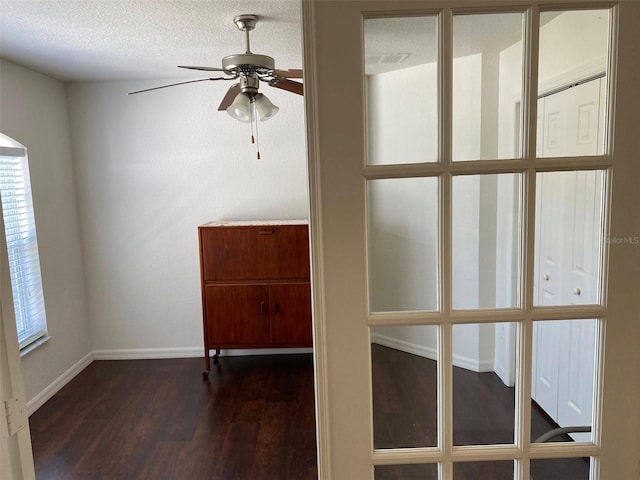 15266 SW 44th Ter, Ocala, FL 34473 - unfurnished room featuring plenty of natural light, ceiling fan, a textured ceiling, baseboards, and dark wood-style floors