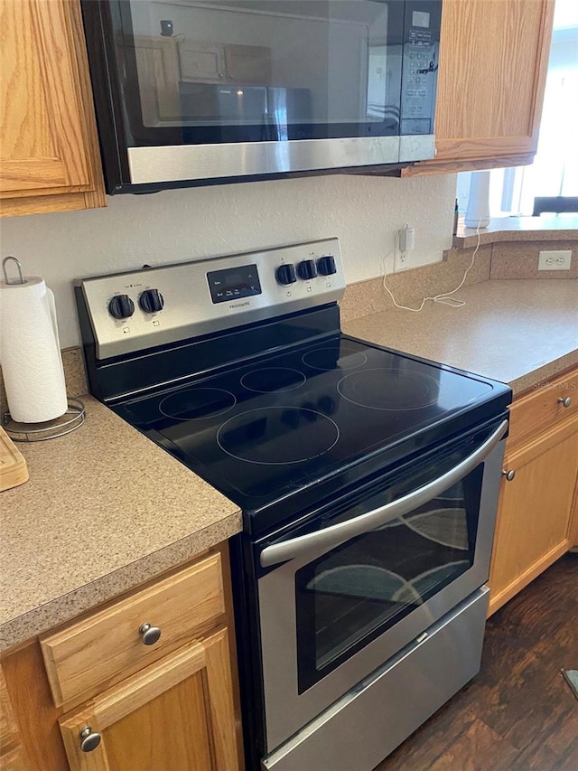 15266 SW 44th Ter, Ocala, FL 34473 - kitchen with light countertops, dark wood-style flooring, and stainless steel appliances