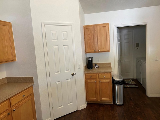 15266 SW 44th Ter, Ocala, FL 34473 - kitchen with baseboards, light countertops, dark wood-style flooring, and washer and dryer