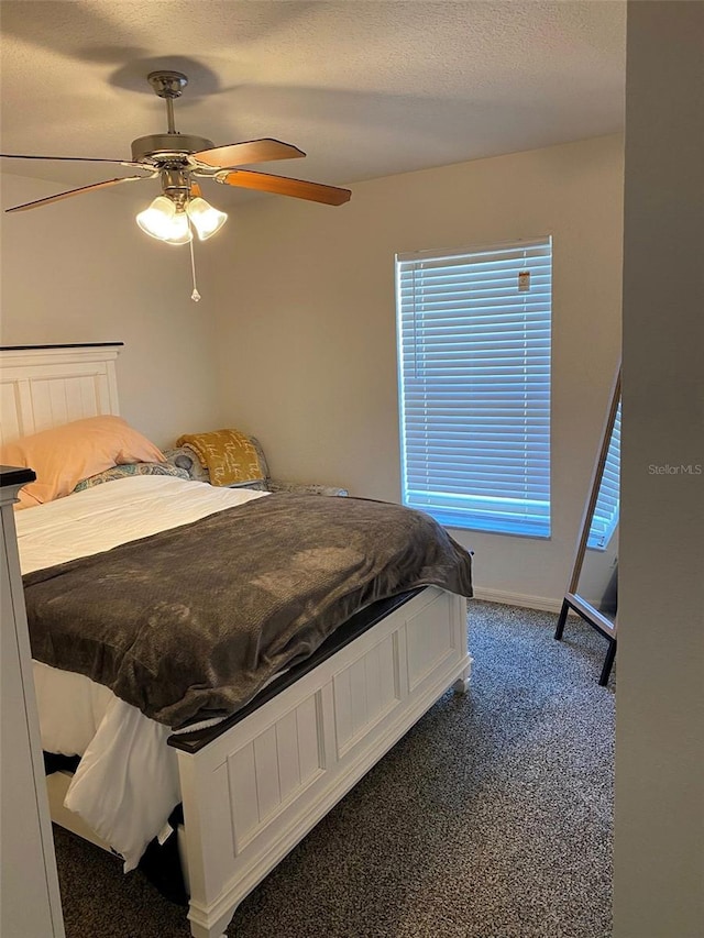 15266 SW 44th Ter, Ocala, FL 34473 - bedroom with baseboards, ceiling fan, dark colored carpet, and a textured ceiling