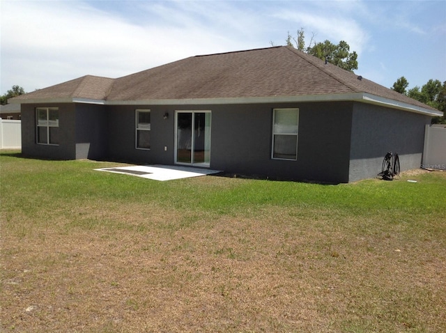 15266 SW 44th Ter, Ocala, FL 34473 - rear view of property with roof with shingles, fence, a yard, a patio, and stucco siding