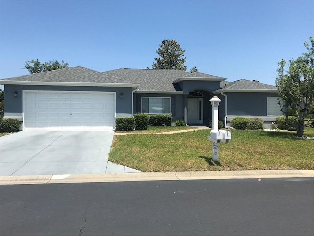 11411 SW 138th Ln, Dunnellon, FL 34432 - ranch-style house featuring driveway, a garage, a front lawn, a shingled roof, and stucco siding