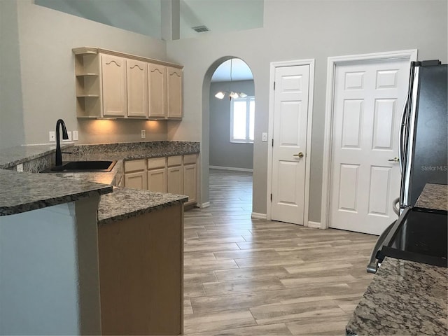 11411 SW 138th Ln, Dunnellon, FL 34432 - kitchen with a sink, light wood-style floors, freestanding refrigerator, and open shelves