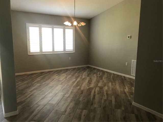 11411 SW 138th Ln, Dunnellon, FL 34432 - empty room featuring baseboards, an inviting chandelier, dark wood-style floors, and visible vents