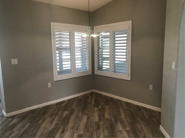 11411 SW 138th Ln, Dunnellon, FL 34432 - unfurnished dining area featuring baseboards, a chandelier, lofted ceiling, and dark wood-style floors