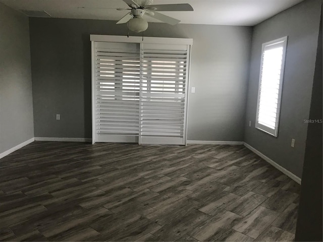 11411 SW 138th Ln, Dunnellon, FL 34432 - spare room with baseboards, ceiling fan, and dark wood-style floors