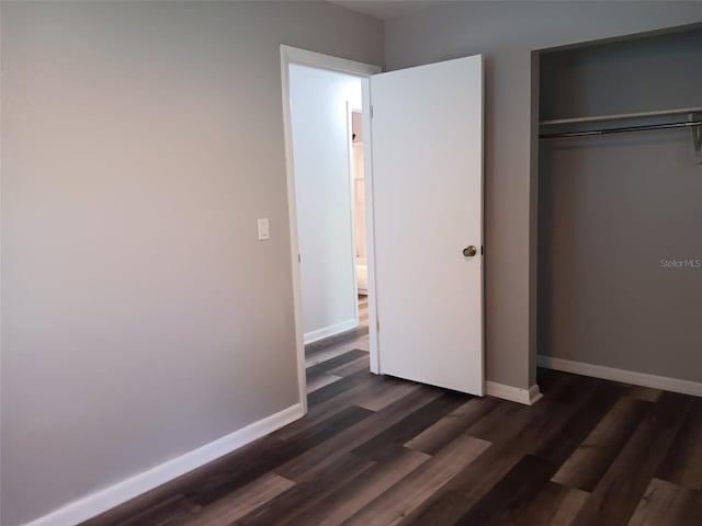 2510 NE 167th Ave, Williston, FL 32696 - unfurnished bedroom with baseboards, dark wood finished floors, and a closet