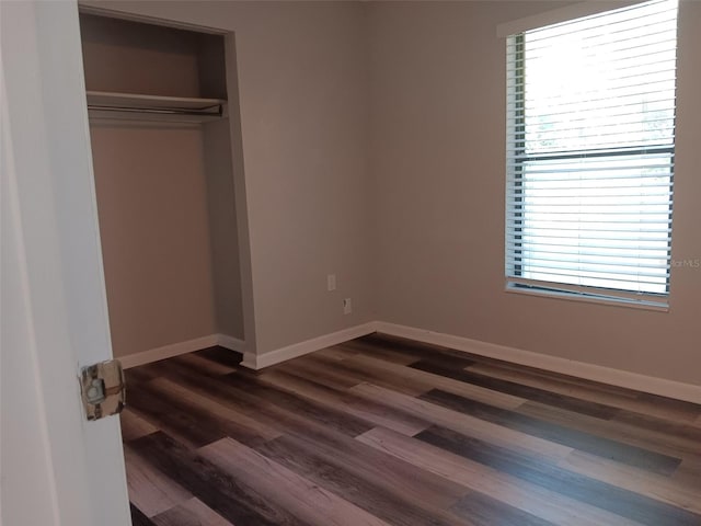 2510 NE 167th Ave, Williston, FL 32696 - unfurnished bedroom featuring baseboards, dark wood-style floors, and a closet
