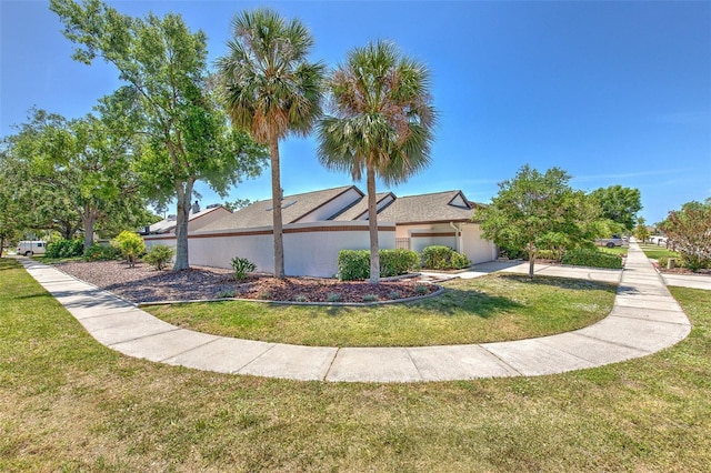 7102 Silvermill Dr, Tampa, FL 33635 - view of side of property with an attached garage, a lawn, and stucco siding