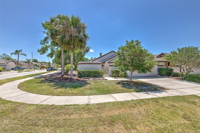 7102 Silvermill Dr, Tampa, FL 33635 - view of property hidden behind natural elements with a front yard, driveway, and a garage