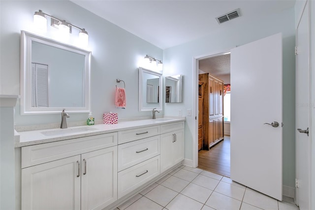 7102 Silvermill Dr, Tampa, FL 33635 - full bath with visible vents, tile patterned flooring, double vanity, and a sink