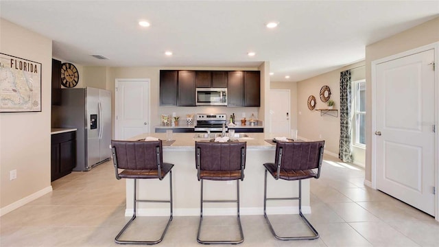 kitchen featuring visible vents, a kitchen breakfast bar, appliances with stainless steel finishes, and recessed lighting