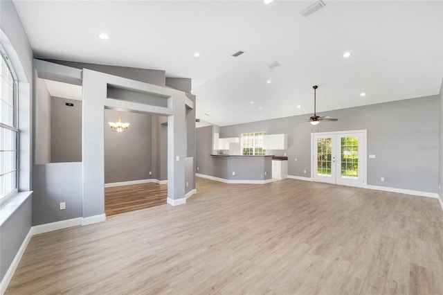 15087 SW 43rd Ct, Ocala, FL 34473 - unfurnished living room with a chandelier, ceiling fan, light wood-style floors, baseboards, and vaulted ceiling