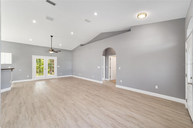 15087 SW 43rd Ct, Ocala, FL 34473 - unfurnished living room with arched walkways, ceiling fan, vaulted ceiling, light wood-style floors, and baseboards