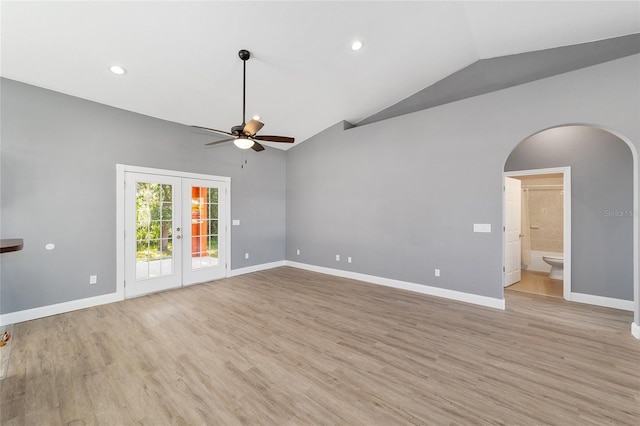 15087 SW 43rd Ct, Ocala, FL 34473 - unfurnished living room with arched walkways, ceiling fan, baseboards, light wood-style floors, and high vaulted ceiling