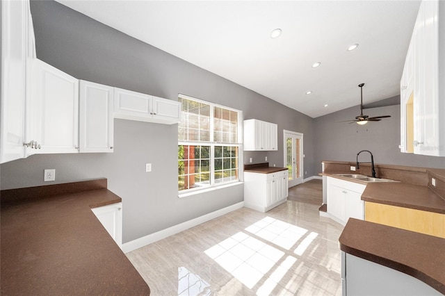 15087 SW 43rd Ct, Ocala, FL 34473 - kitchen with a sink, vaulted ceiling, white cabinetry, ceiling fan, and light wood-type flooring