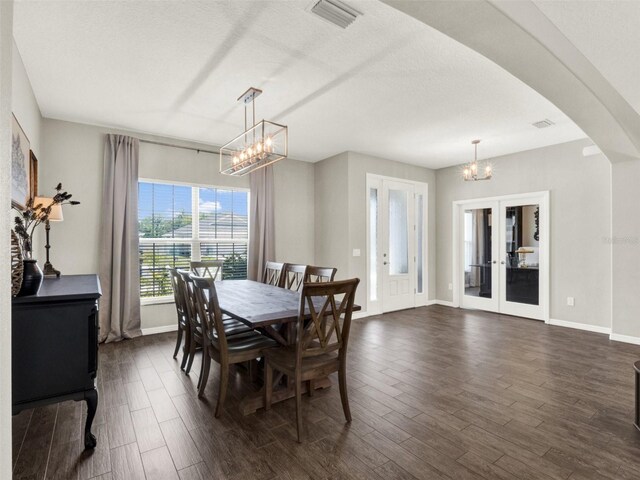 4806 NW 8th Ter, Ocala, FL 34475 - dining space featuring visible vents, arched walkways, baseboards, a notable chandelier, and dark wood-type flooring